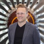 Mark standing in front of an turbine blade.
